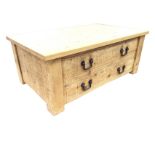 A reproduction rectangular rustic pine coffee table with plank top above two long drawers opposing