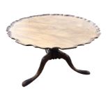 A circular mahogany scalloped top coffee table, reduced from a Georgian snap-top, the wide tray