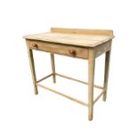 A pine washstand table with rectangular moulded top above a knobbed frieze drawer, raised on