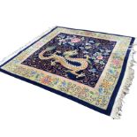 A square contemporary Chinese thick pile rug woven with dragon, foliage and scrolling on blue field,
