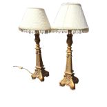 A pair of decorative faux bronze tablelamps with classical leaf cast gilded columns on square