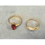 A 9ct gold ring set with an elliptical cut ruby stone; and another 9ct gold ring with twisted
