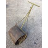 A Victorian cast iron garden roller with scrolled brackets to T-handle, the weighted drum