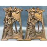 A pair of art nouveau bronze photo frames cast with military style goddess figures holding liberty