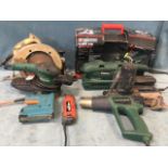Four Black & Decker power tools - a staple gun, a heavy duty rip saw, a hand grinder and a long-