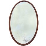 A large oval Victorian mahogany mirror with bevelled plate in moulded frame. (44.5in x 24.5in)