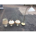 A pair of ceramic tablelamps with conical tasseled shades, a crackle glazed ceramic tablelamp, and a