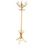 A beech bentwood coatstand with six scrolled hooks to column above a base with waisted supports