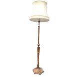 A walnut standard lamp with turned column on tapering hexagonal support with moulded base, fitted