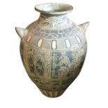 A large Mexican terracotta vase with incised sgraffito decoration, having stylised figural frieze