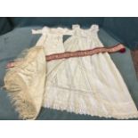 A Victorian lacework christening gown; a silk floral embroidered European head cover with tasseled