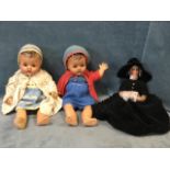 A pair of composition C20th dolls with sleep eyes and jointed bodies, wearing original knitted