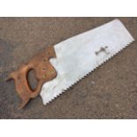 An advertising sign with Spear & Jackson giant saw having shaped oak handle, the aluminium blade