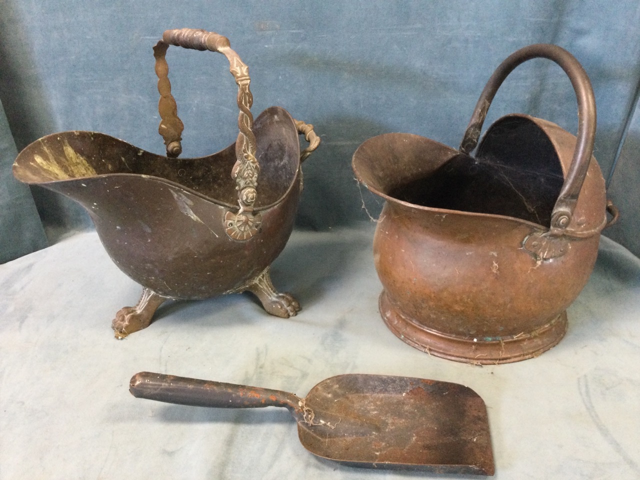 A Victorian helmet shaped copper coal skuttle with serpent cast swing handle, raised on claw feet;