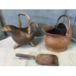 A Victorian helmet shaped copper coal skuttle with serpent cast swing handle, raised on claw feet;