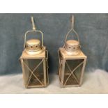 A pair of German second world war lanterns with bun shaped chimneys to square glazed enclosures,