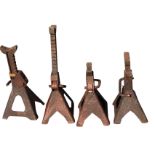 A set of four iron jacks with spanner shaped supports on ratchets, each raised on angled square