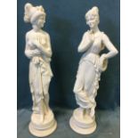 A pair of faux marble figurines modelled as elegant classical ladies, one contemplative and the