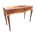 A Whytock & Reid serpentine fronted side table, the moulded top above two frieze drawers mounted