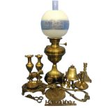 A Victorian brass oil lamp with acid etched globe shade above a moulded reservoir on a wheatear cast