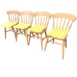 A set of four slatback kitchen chairs with button upholstered loose cushions to solid seats,