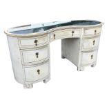 A painted kidney shaped dressing table with mirrored glass to moulded top, having central kneehole