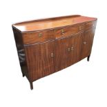 A bowfronted mahogany Strongbow sideboard with three frieze drawers above cupboards, raised on