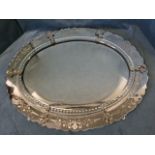 An oval Venetian style mirror, the bevelled plate in border cut with roundel facets, the outer rim