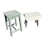 A rectangular painted wood stool raised on angled tapering legs, with metal caping to front rail;