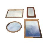 A rectangular oak framed mirror with cut-corner bevelled plate in frame with sun carved top