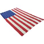 A large American stars & stripes flag - holed. (97in x 57in)