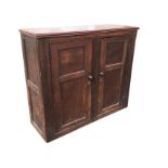 A nineteenth century oak cupboard with later alterations, the panelled doors in ribbed frames