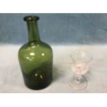 An early mallet shaped wine bottle with indented base and tubular neck with moulded rim; and a