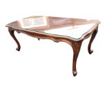 A rectangular scalloped mahogany coffee table with plate glass to top, with shaped carved aprons