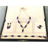 A cased South American lapis lazuli parure with elliptical panels set in silver - a bracelet, a