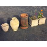 A pair of square fluted composition stone garden tubs; a Victorian tapering terracotta chimney