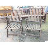 A pair of Danish folding garden armchairs with slatted backs and seats, raised on rectangular shaped