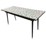 A rectangular 60s kitchen table with mosaic tile rectangular top in ebonised frame, supported on