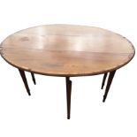 An oval antique mahogany dining table with two drop leaves, the moulded top crossbanded in rosewood,