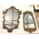 A carved wood framed mirror with arched bevelled plate surmounted by pierced leaf scrolls framing