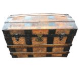 A domed top leather lined seamans chest with oak slats and metal mounts, fitted with brass hasp to