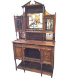 A Victorian rosewood dresser inlaid with foliate marquetry, having swan neck pediment above a