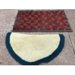 An Indian rug woven with serrated leaf medallions on red ground framed by flowerhead border - 32.5in