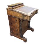 A Victorian walnut davenport inlaid with satinwood banding, the desk with tooled leather skiver to