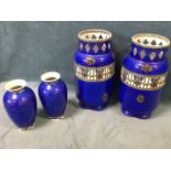 A pair of tubular Fenton vases decorated with grill friezes and ribbon swags on blue ground, with