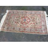 A fine Turkish Kayseri knotted wool rug woven with central orange floral medallion on busy grey