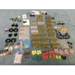 A box of miscellaneous pairs of earrings, ear studs, drop pendant earrings, many still packaged,