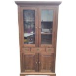 A reproduction glazed bookcase cabinet with moulded cornice above glass doors enclosing shelves,