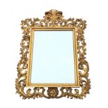 A Queen Anne style carved giltwood mirror, the moulded frame with wide border of pierced leaf