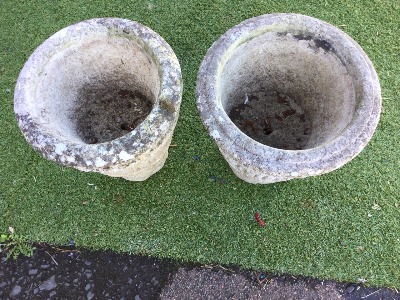 A pair of composition stone urns with moulded rims above tapering fluted bucket shaped pots, - Image 2 of 3